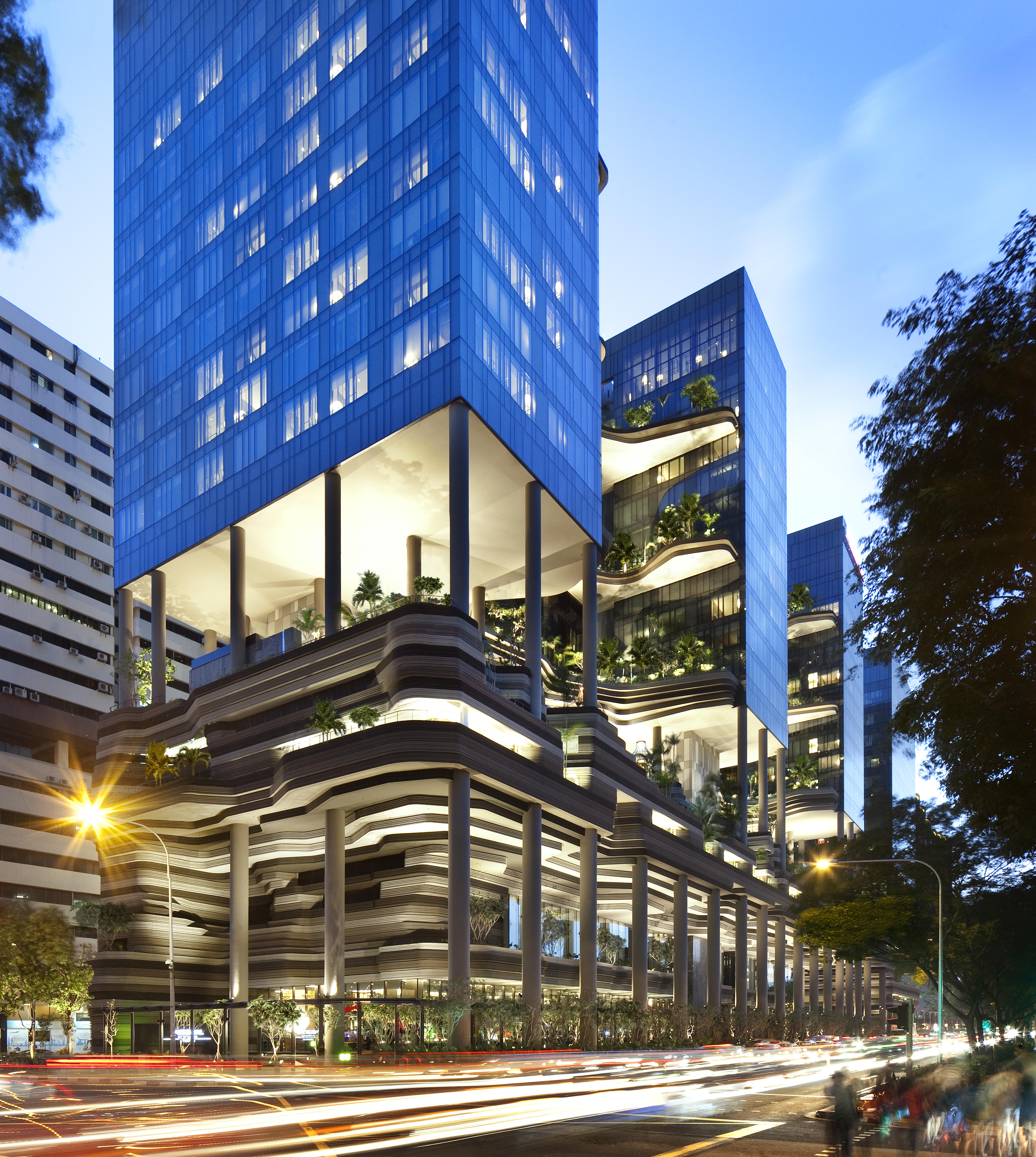 Parkroyal Collection Pickering, Singapura Luaran gambar The photo shows a modern architectural complex featuring multiple tall buildings with sleek glass facades. The design incorporates various levels and terraces, showcasing greenery and plants integrated into the structure. The lower portion of the bui